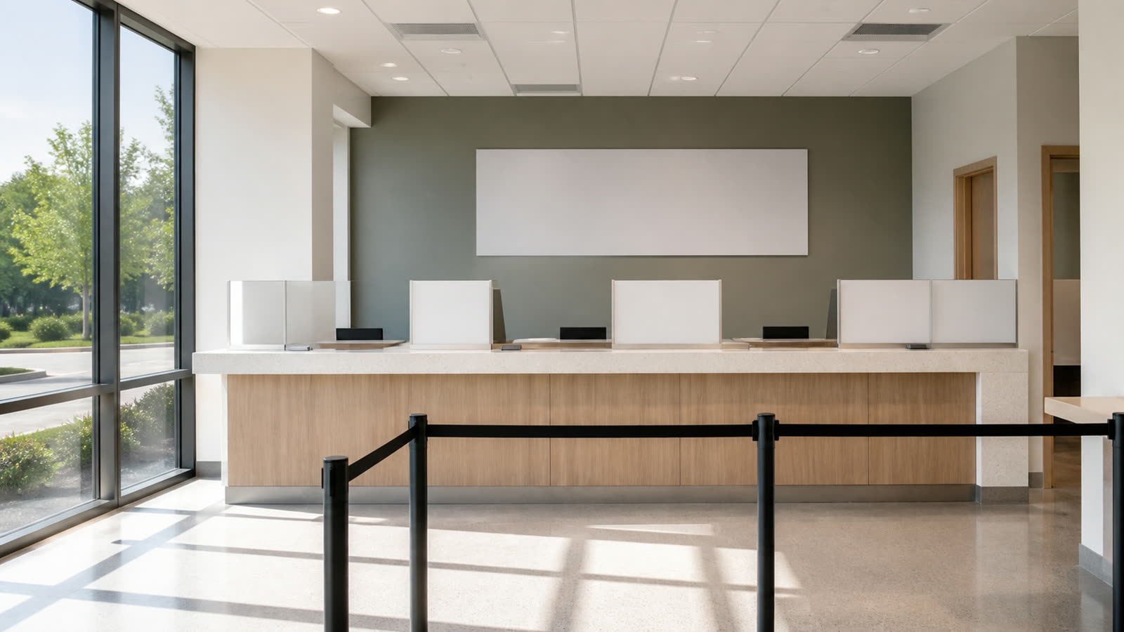 An empty public service counter with a barrier rope in front of it
