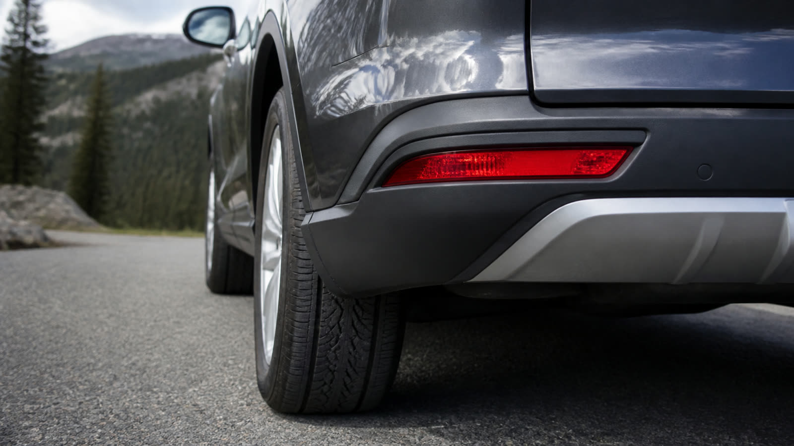 The rear lights and tire of a car, the parts an examiner checks before a road test